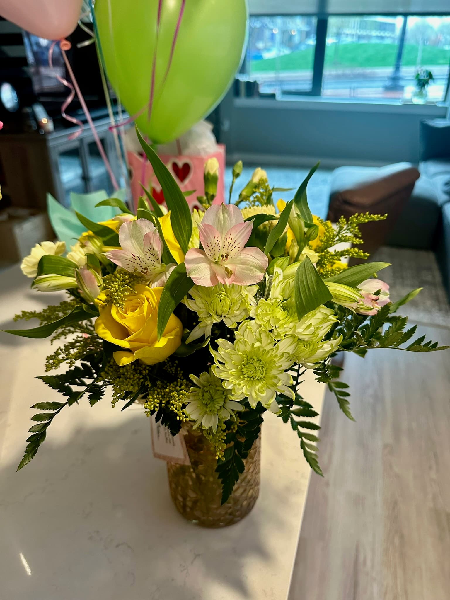 Fresh flower bouquet with balloons in background