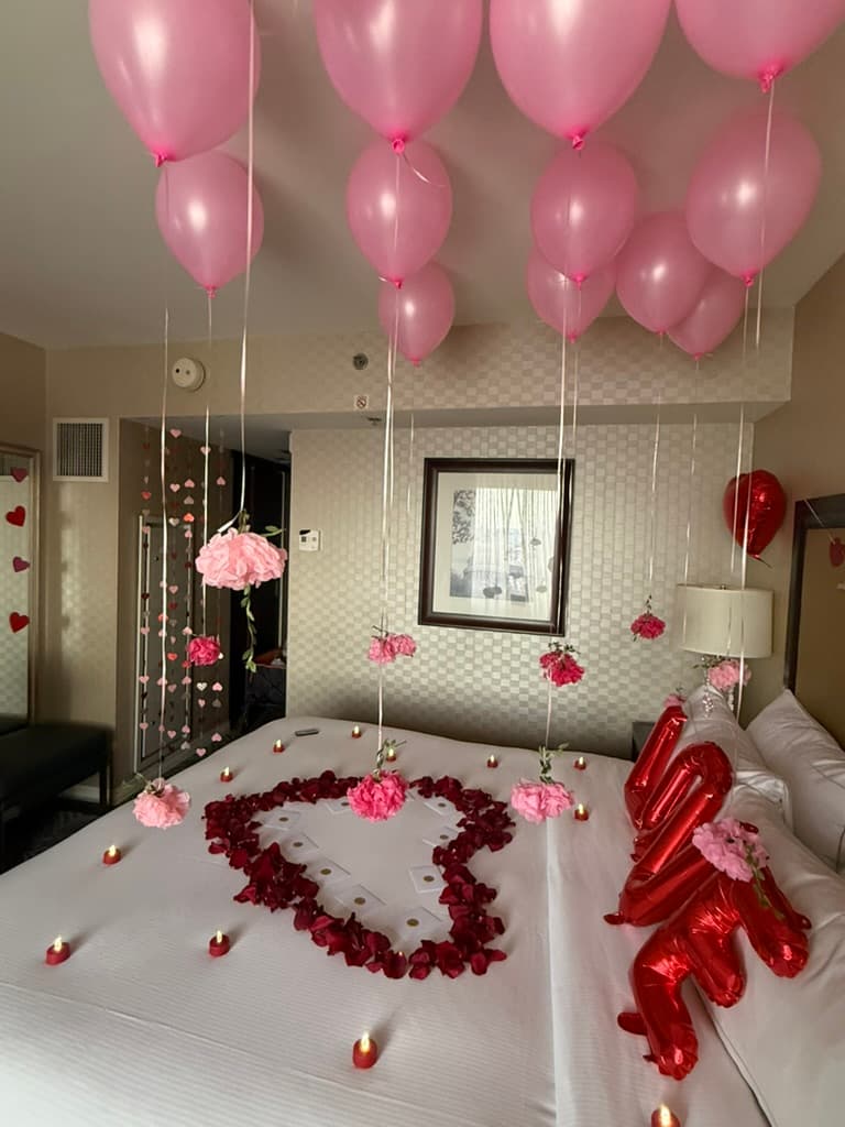 Floating pink balloons above the bed