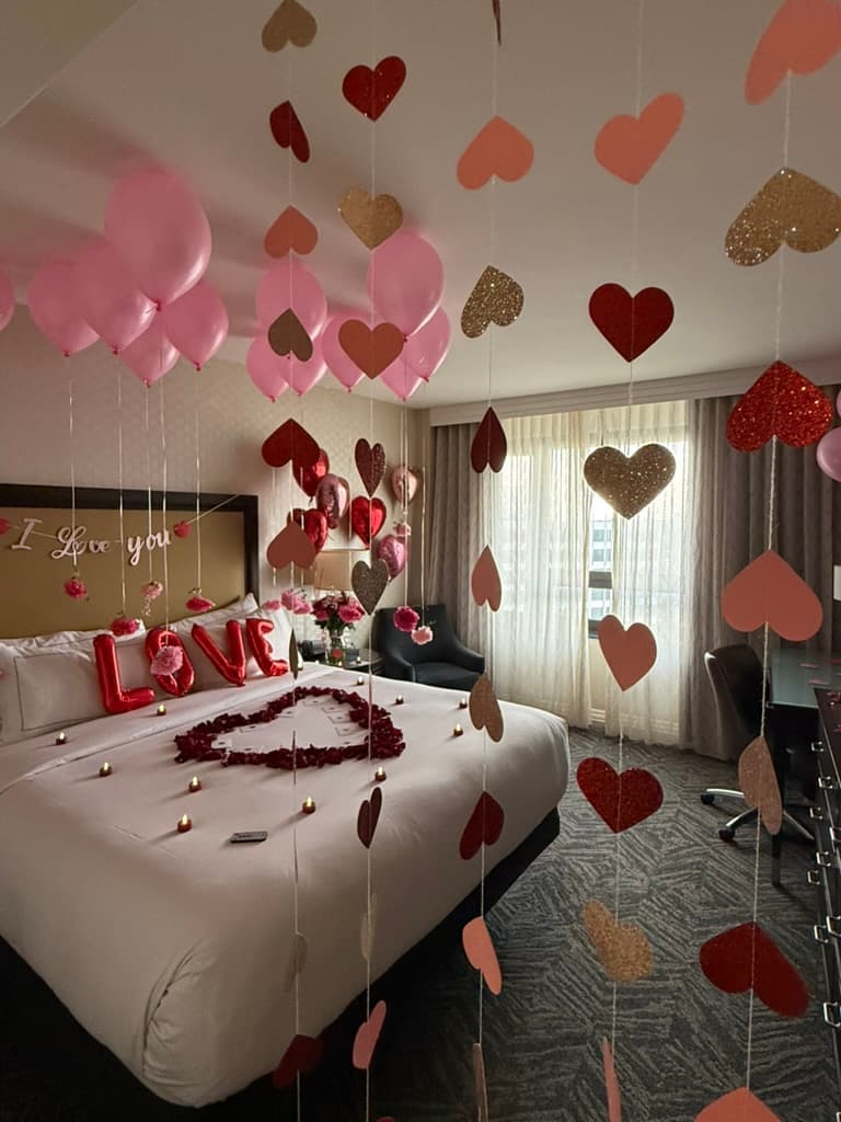 Pink balloon canopy with hanging heart garland