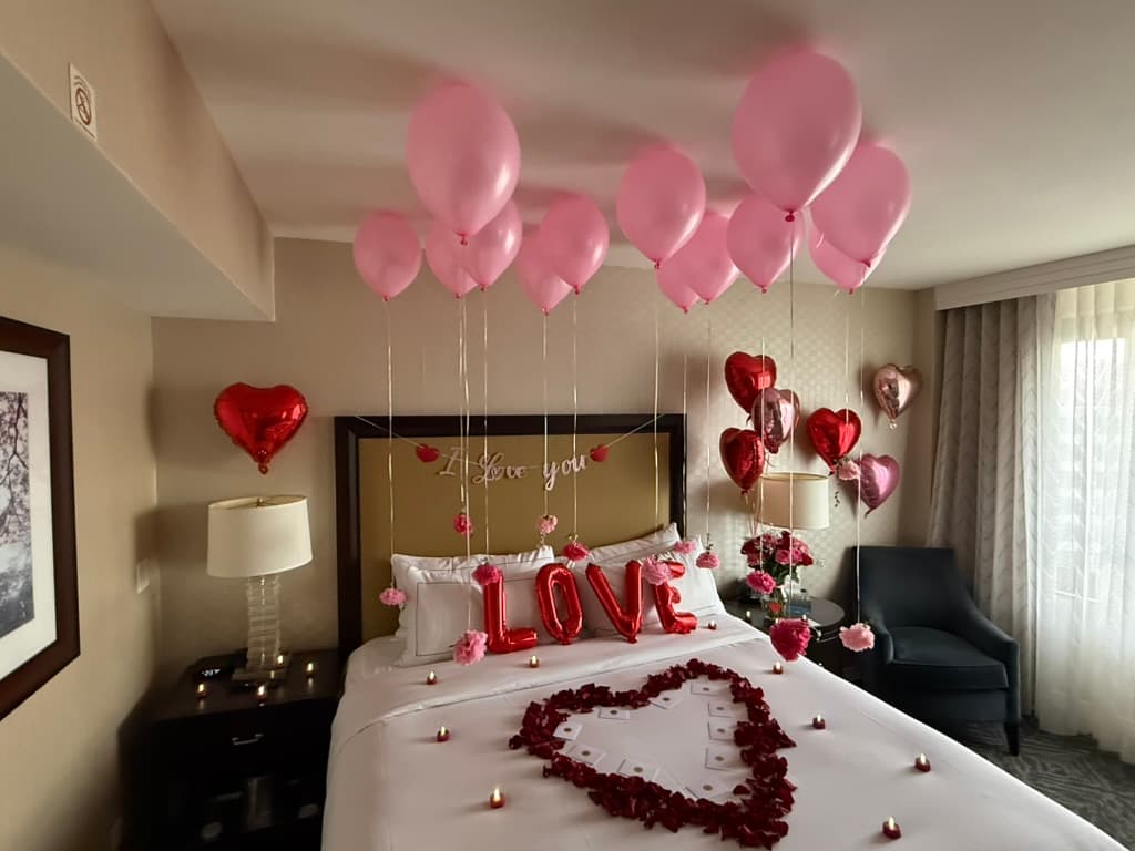 Pink balloons and LOVE pillows with rose petal heart