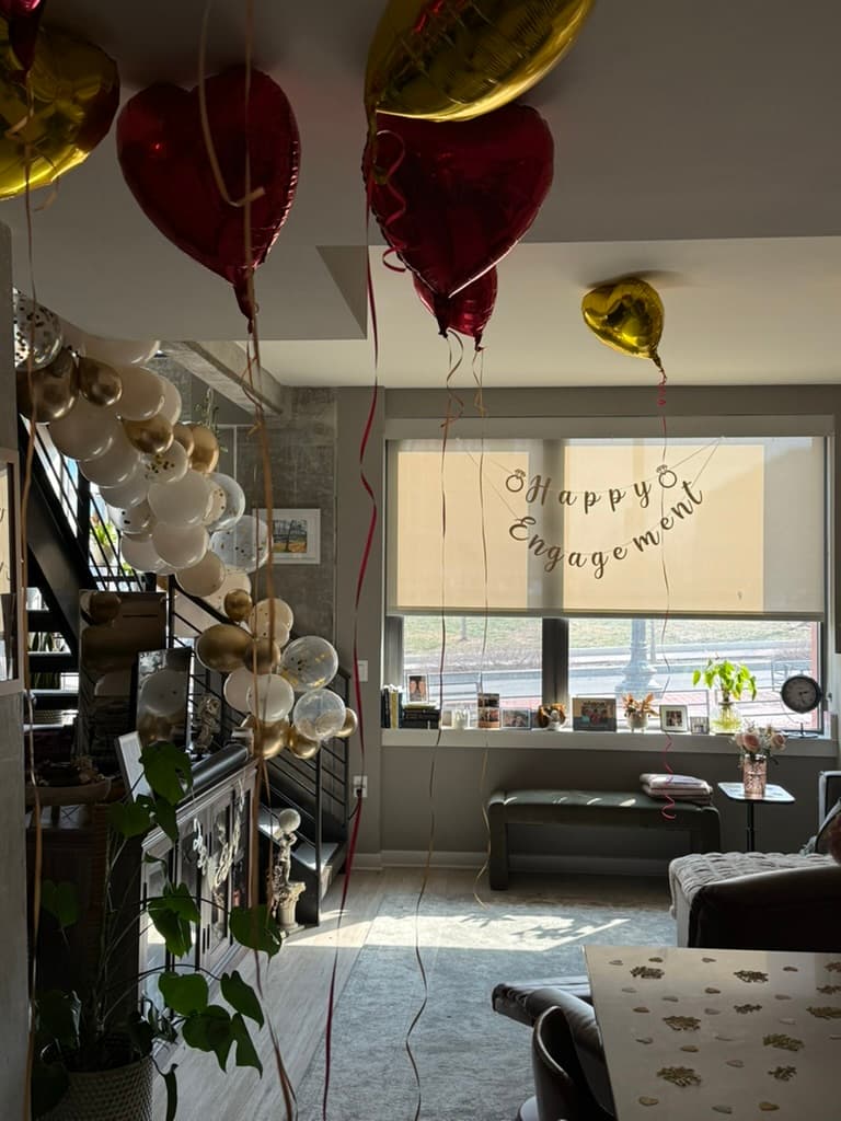 Engagement setup with heart balloons and staircase garland